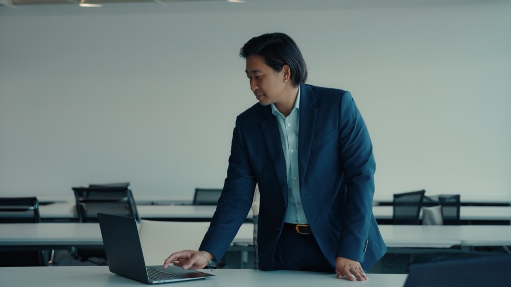 Real estate agent working at a desk in a modern agency office