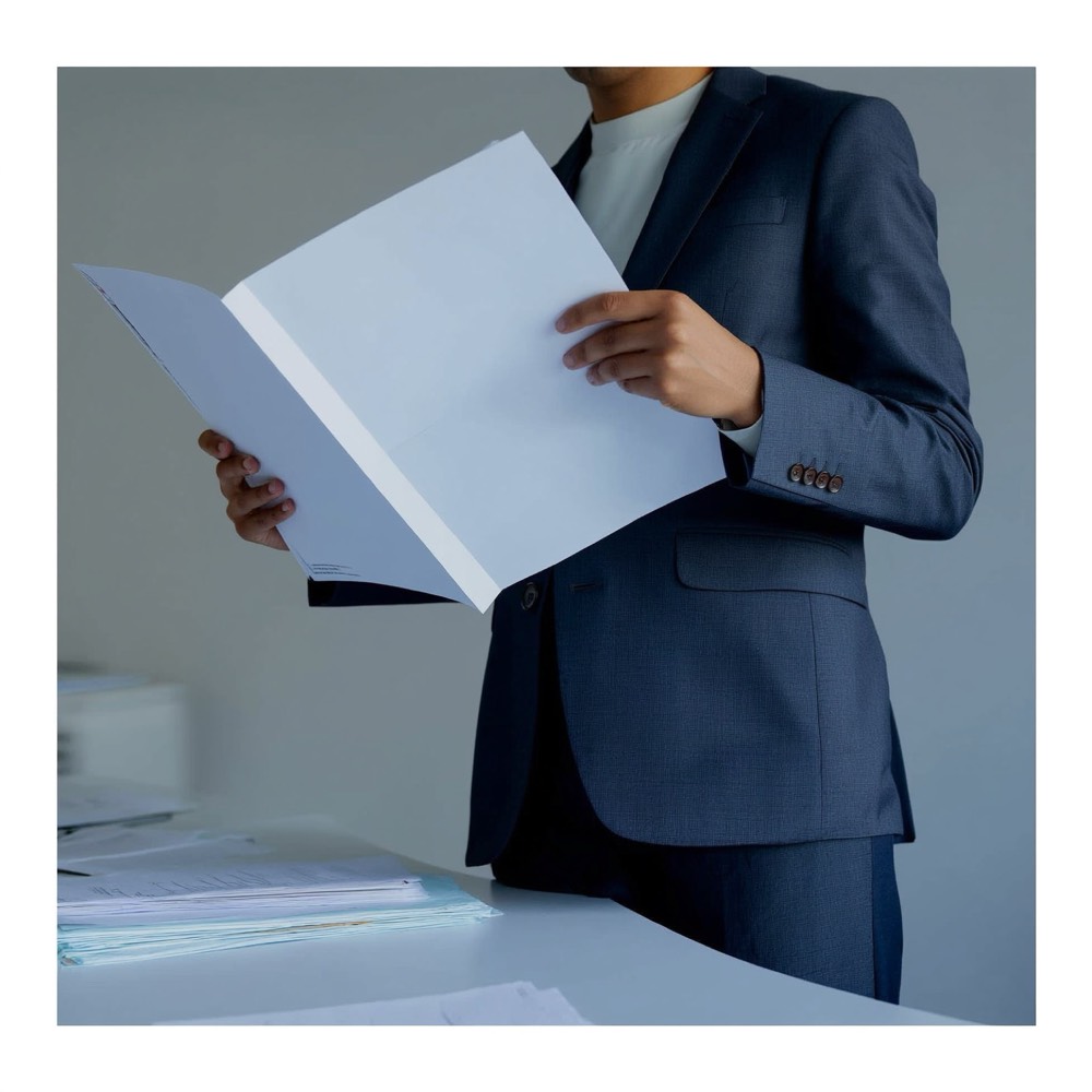 Organised compliance folder and documents on a desk